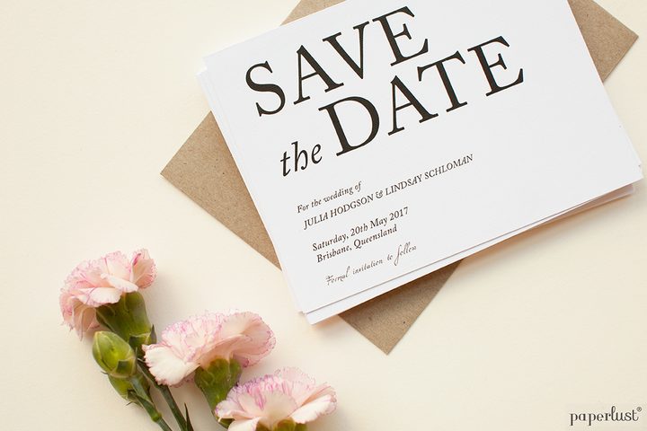 Paperlust bold typographic save the date card on kraft envelope with addressing in hand
