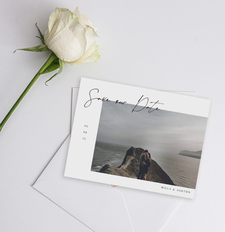 Paperlust landscape save the date card with couple photo on a misty clifftop in muted neutral palette