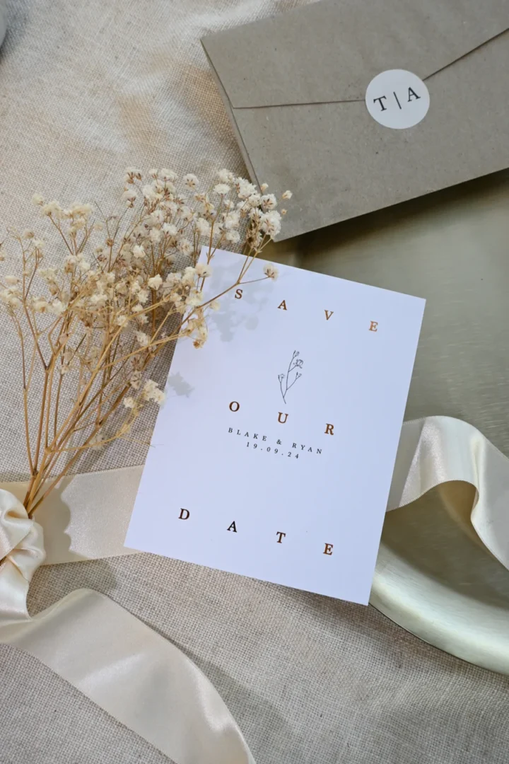 Paperlust kraft envelope save the date flat lay with silk ribbon