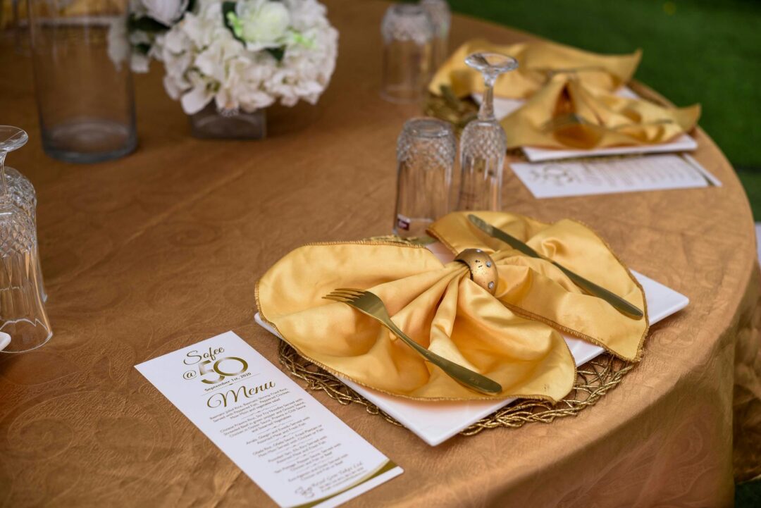 Close-up of a formal wedding menu card with elegant calligraphy typography laid flat on a table setting