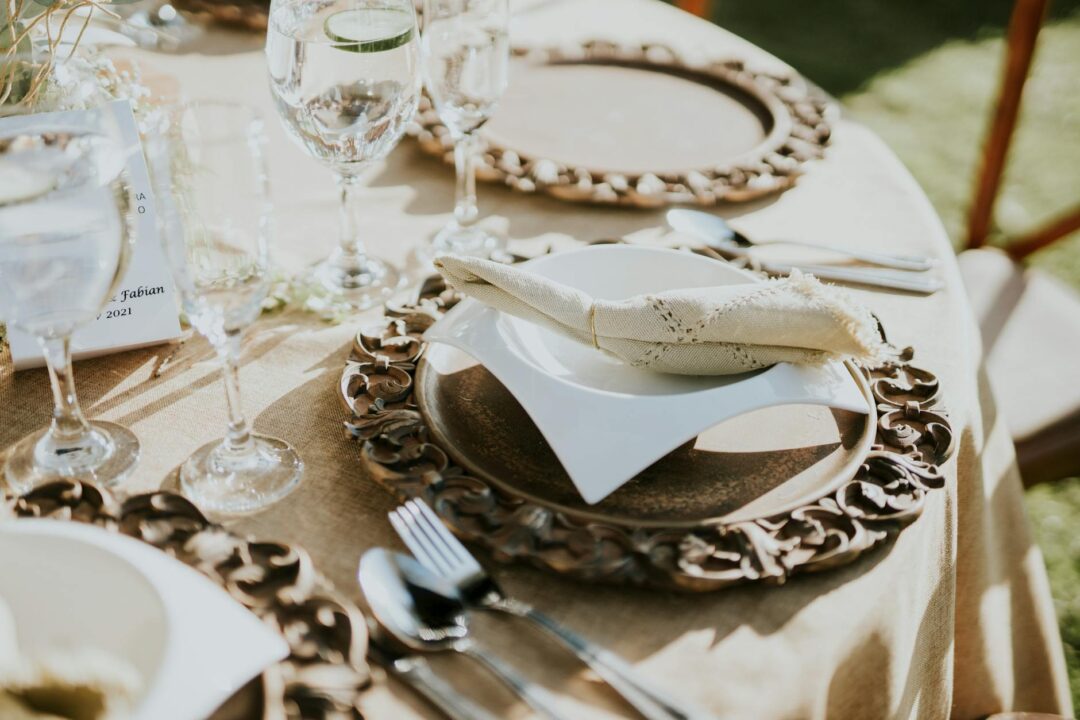 Wedding menu cards styled on a rustic tablescape with dried flowers and linen napkins in a warm, earthy palette