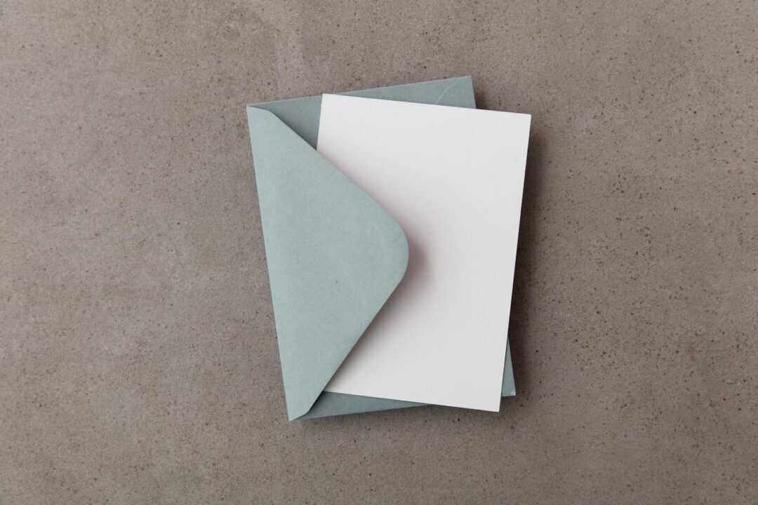 Paperlust save the date card and invitation side by side, showing coordinated design suite on a flat surface