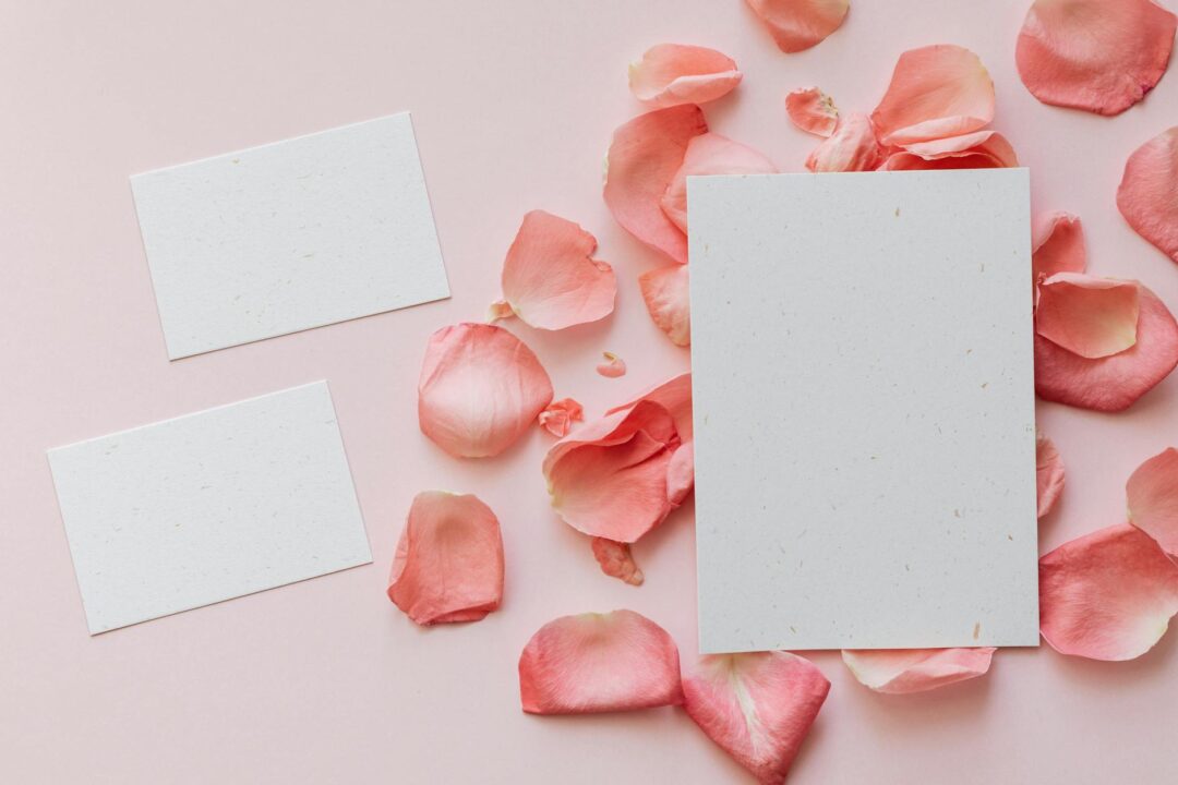 Overhead shot of Paperlust wedding invitation suite spread on a marble table, showing invitation, RSVP card, information card, and addressed
