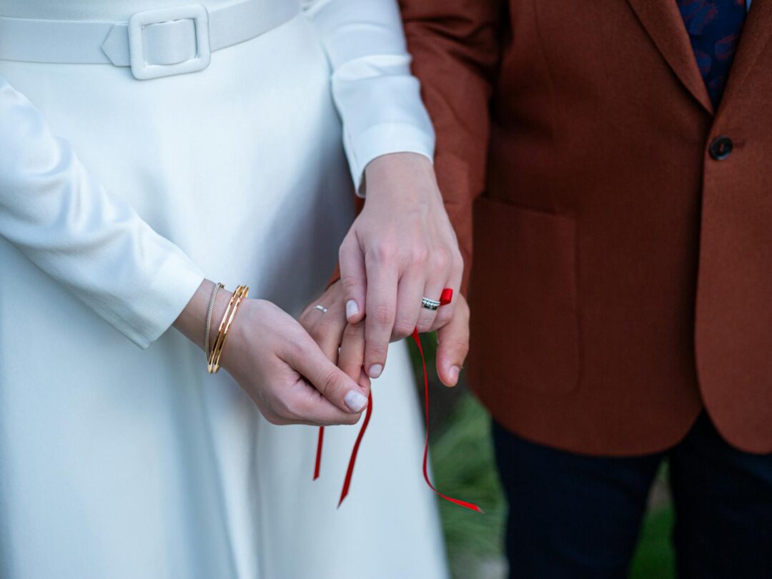 handfasting ceremony with braided cords wrapped around couple's joined hands