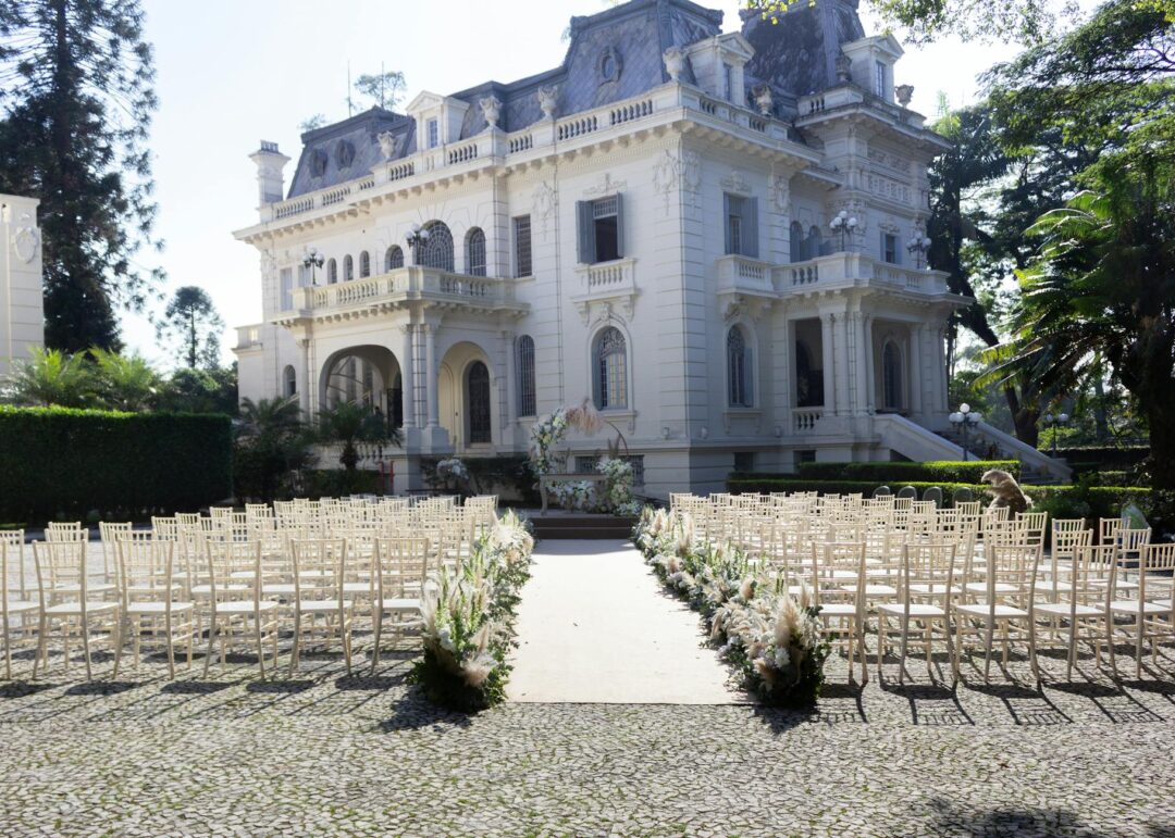 garden wedding ceremony aisle with vintage rug runner, scattered rose petals, lush greenery and wildflowers on each side, natural daylight