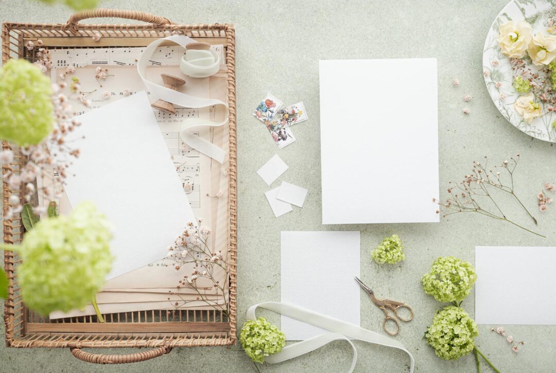 Beautifully styled wedding invitation flatlay featuring a vellum belly band with wax seal and botanical design on neutral linen surface, rep
