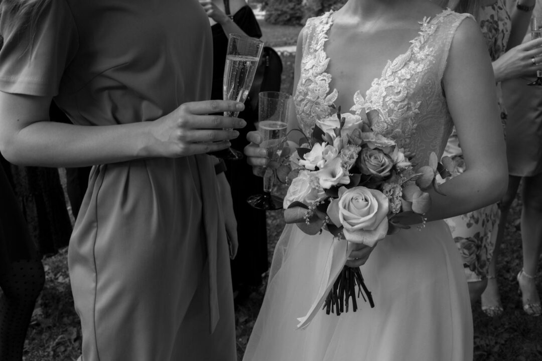 wedding guests enjoying passed canapés at a cocktail hour, waitstaff in white presenting elegant trays at an outdoor Australian reception ve