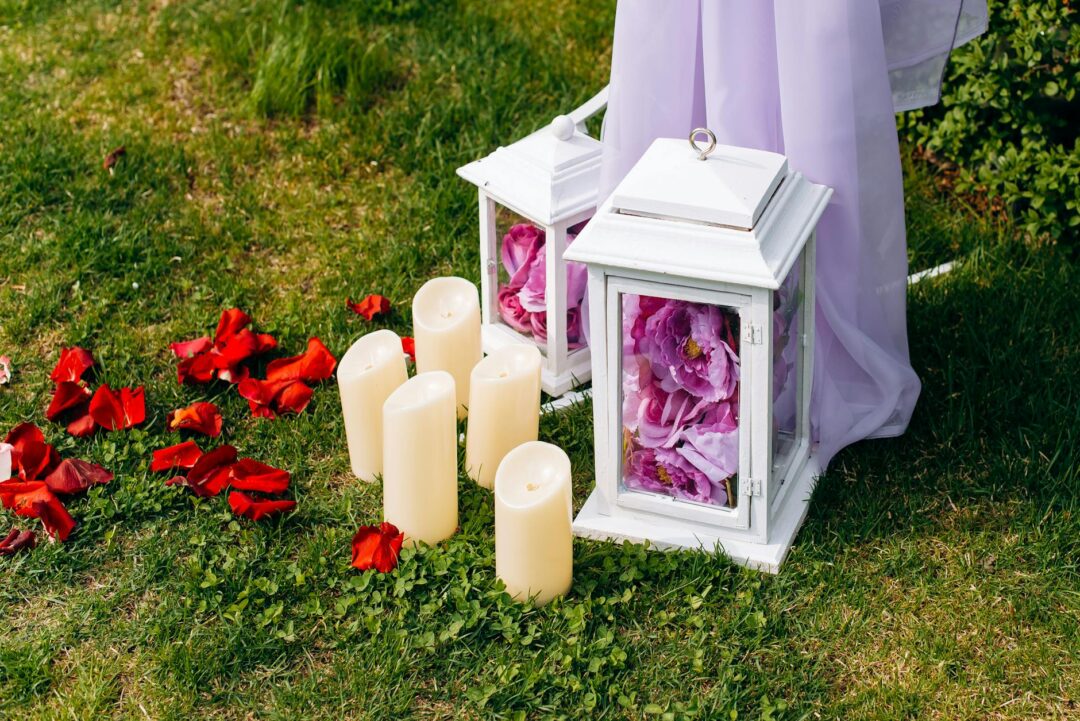 aisle decorated with lanterns and petal-strewn runner at an outdoor garden ceremony