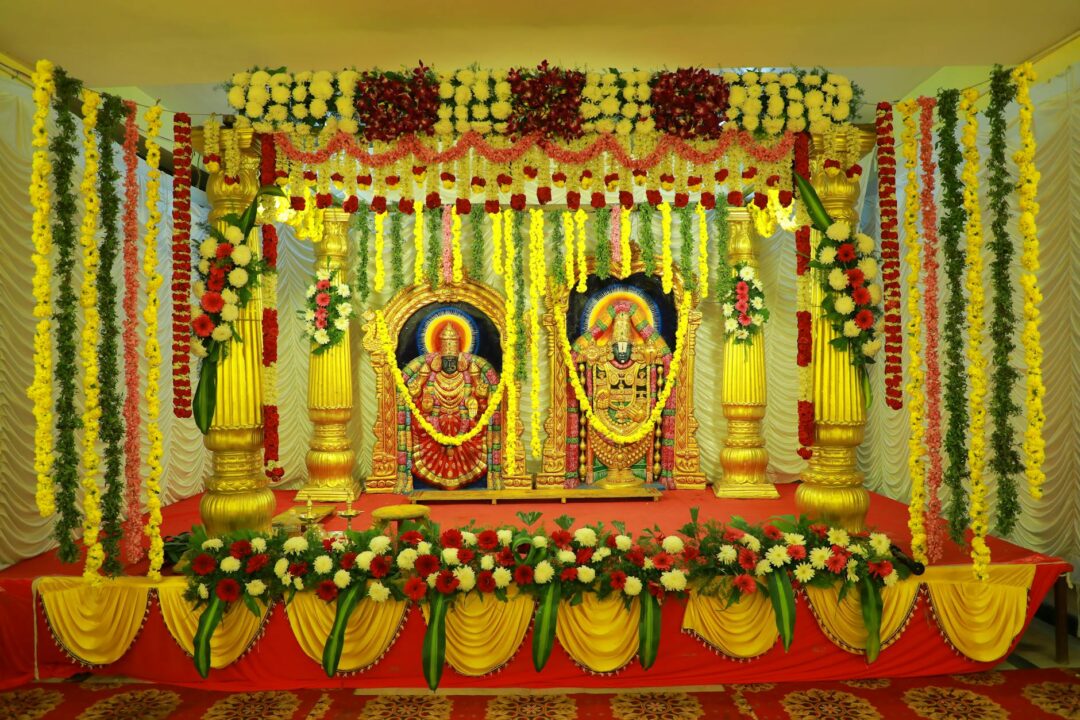 Hindu ceremony mandap with marigold and rose floral garlands in orange and yellow tones