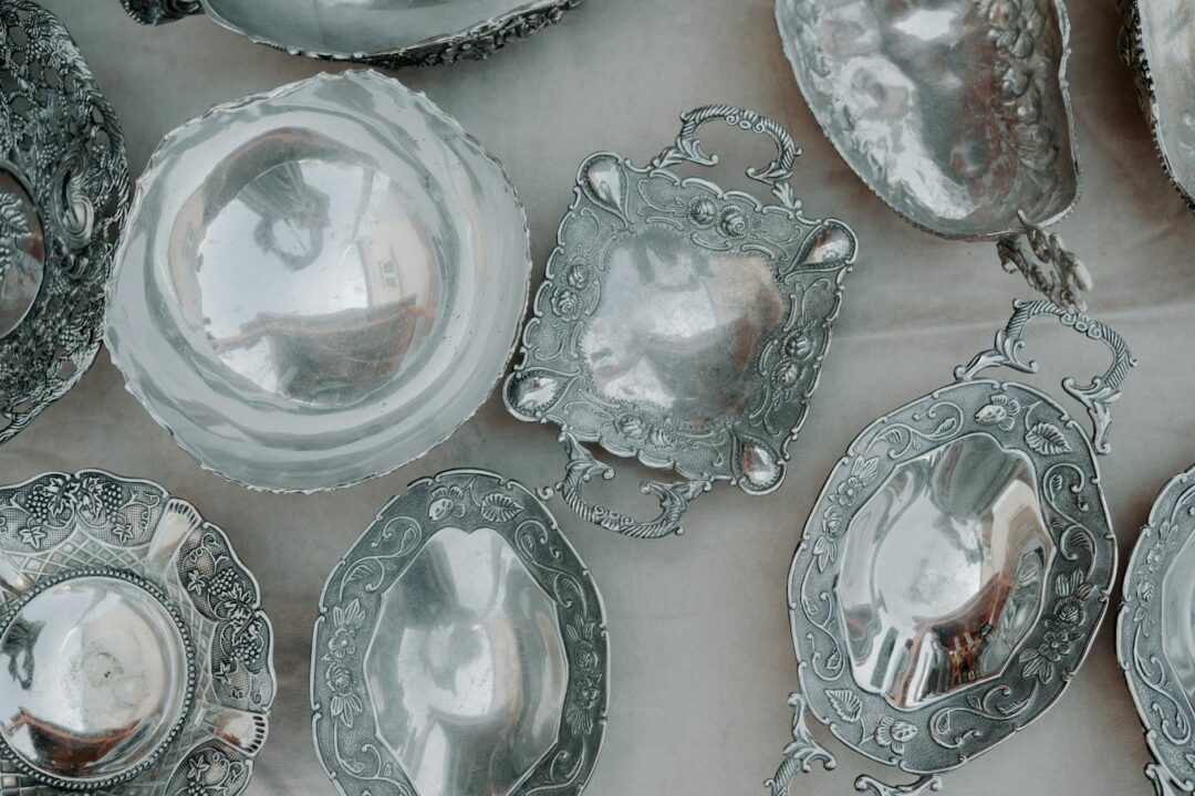 close-up overhead shot of a server's silver tray with three varieties of elegant passed appetizers at a wedding cocktail hour, arancini, min