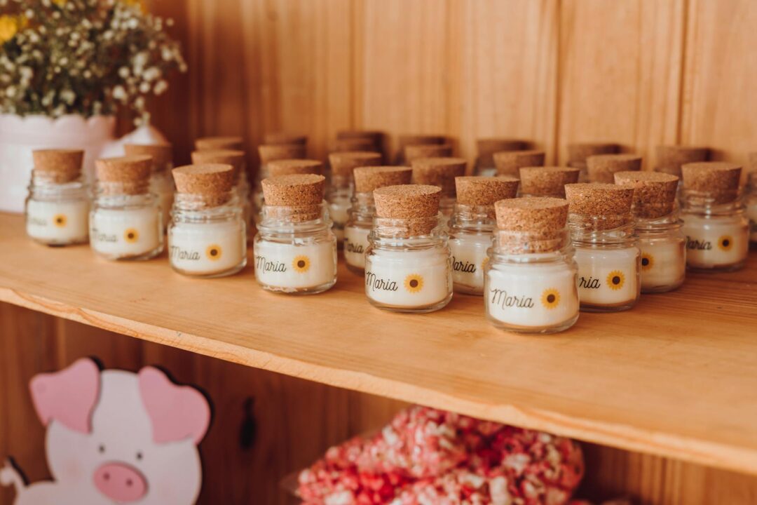 wedding favor display featuring small potted succulents and seed packets with calligraphy tags tied in natural twine, arranged on a wooden c