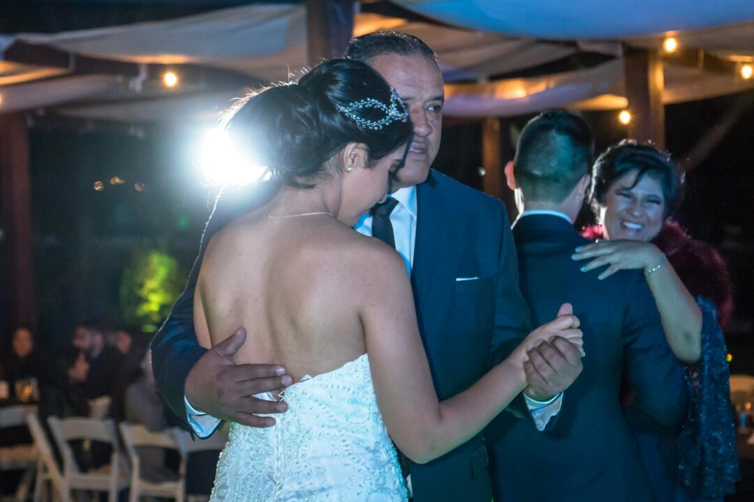 first look with father of the bride, dad wiping eye as daughter appears in dress, emotional outdoor setting, morning light