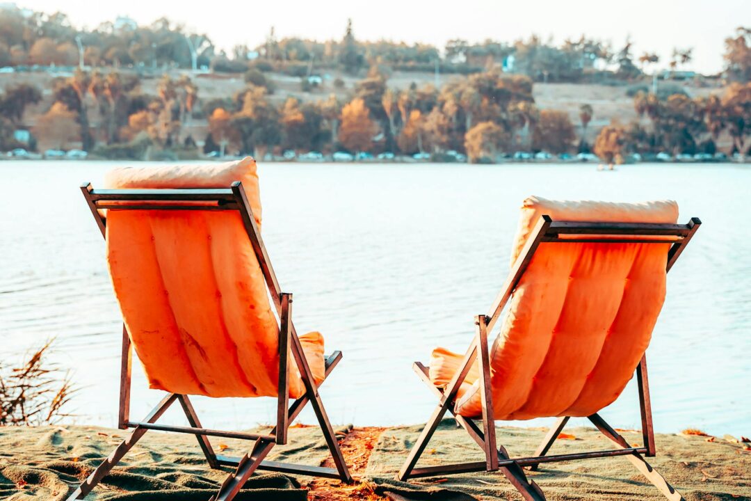 Wedding ceremony chairs facing river at golden hour