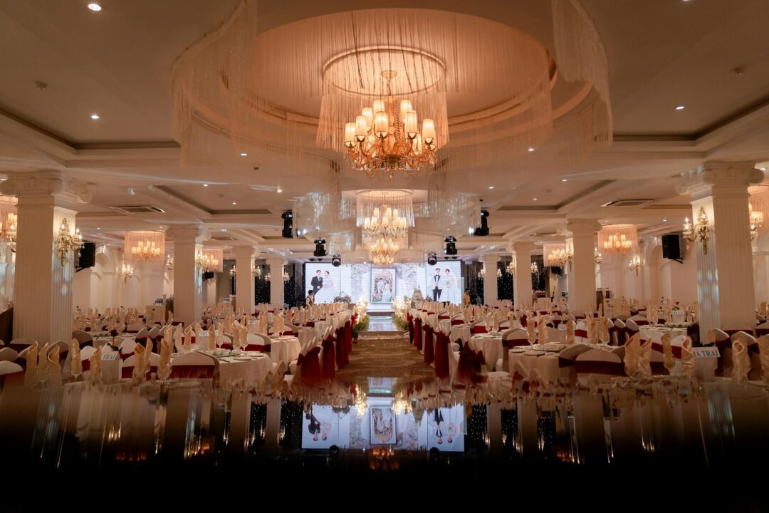 Grand ballroom wedding reception with crystal chandeliers