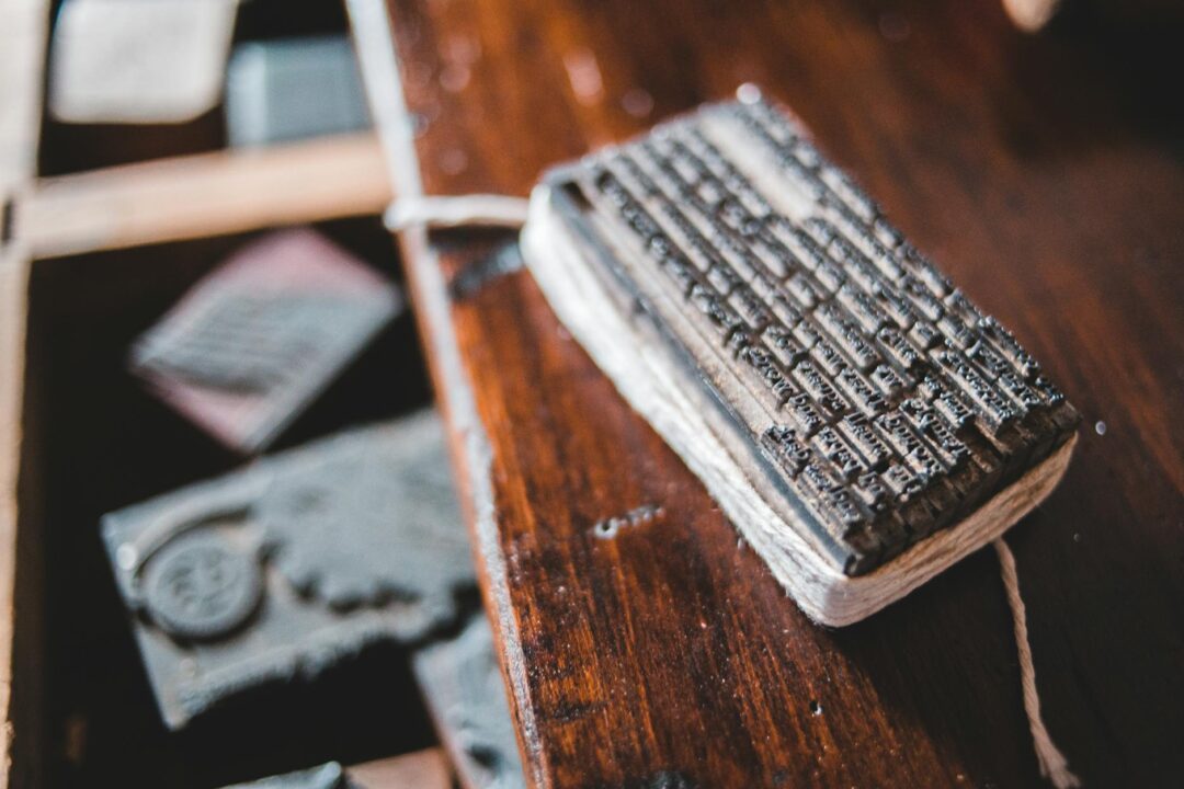 Cream and navy letterpress wedding invitations on warm timber