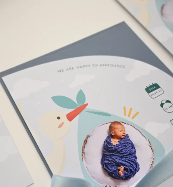 Paperlust birth announcement card product shot with newborn photo and blue ribbon