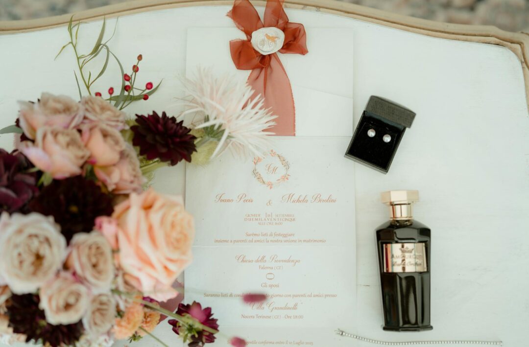 Paperlust elegant wedding invitation suite flat lay featuring watercolor wildflower wreath design, gatefold format, monogram initials, fresh