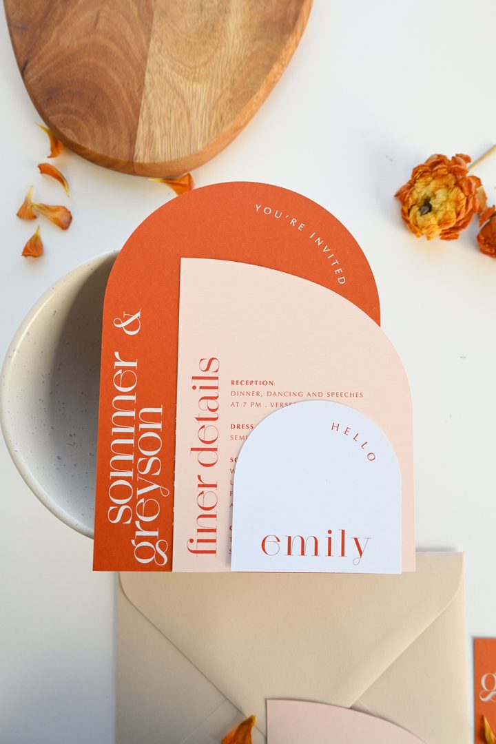 Paperlust invitation, Beautifully styled wedding stationery suite with arch-shaped pieces in a warm terracotta and blush color palette. Excellent composition with dried florals and petals as props