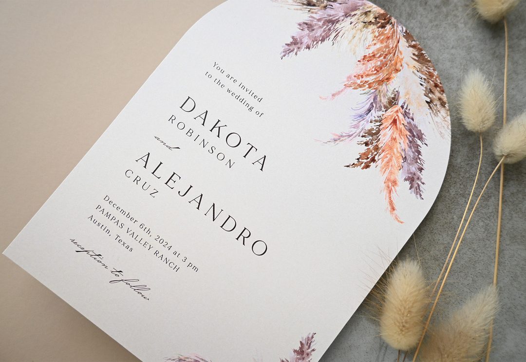 Paperlust invitation, Beautifully styled wedding invitation featuring pampas grass watercolor illustrations with dried bunny tail props. The invitation shows a US location (Austin
