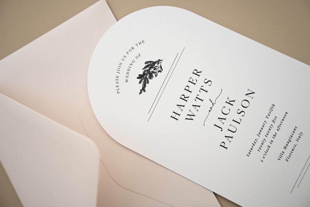 Paperlust invitation, Beautifully styled wedding invitation with arch-shaped card and blush envelope. Elegant typography with botanical motif