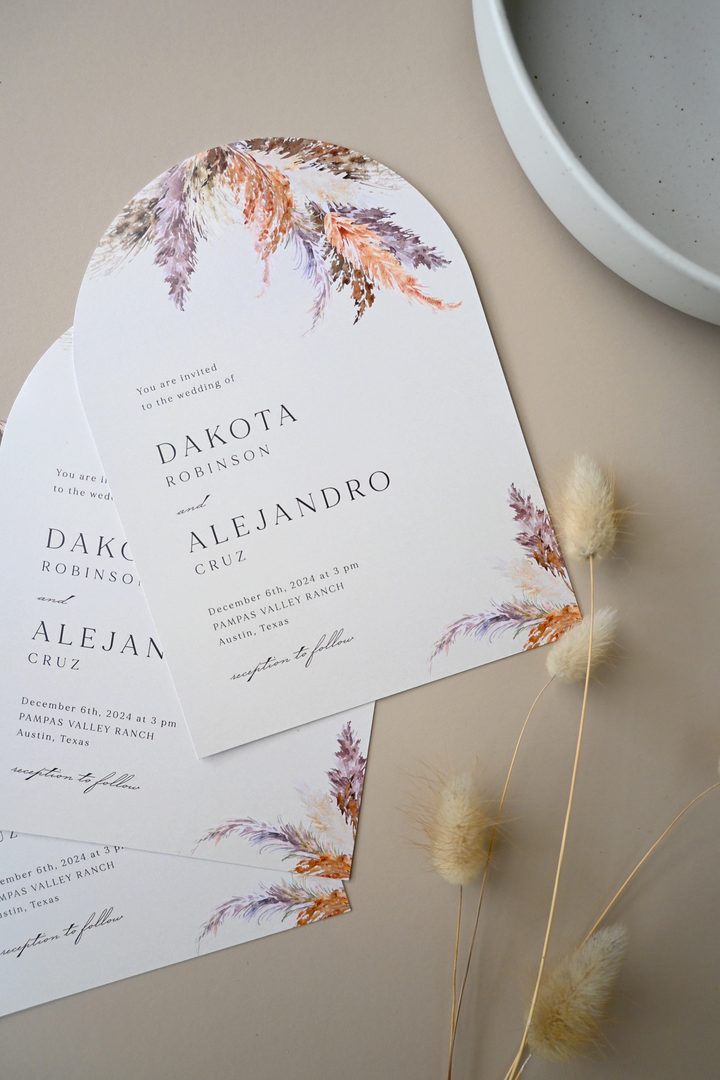 Paperlust invitation, Beautifully styled flatlay of arch-shaped wedding invitations featuring pampas grass watercolor illustrations