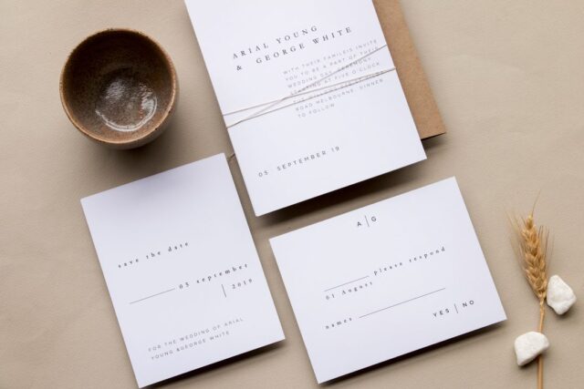 Paperlust invitation, Beautifully styled minimalist wedding suite flatlay with warm neutral tones and natural props. The invitation text references Melbourne
