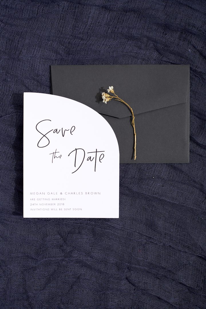 Paperlust invitation, Beautifully styled save-the-date card with arch shape on dark moody linen