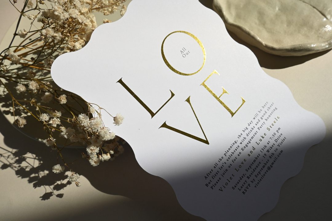 Paperlust invitation, Beautifully styled engagement party invitation with gold foil lettering spelling 'LOVE'
