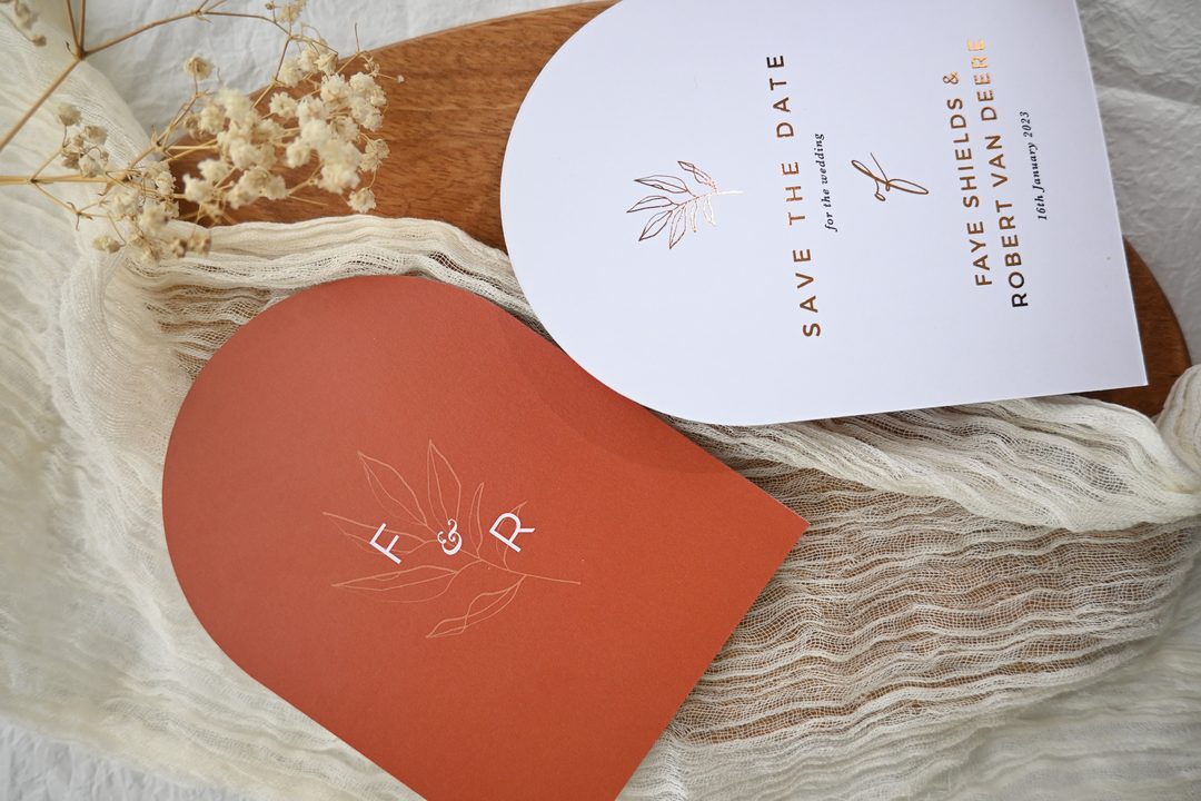 Paperlust invitation, Beautifully styled save-the-date card and terracotta arch envelope with foil lettering