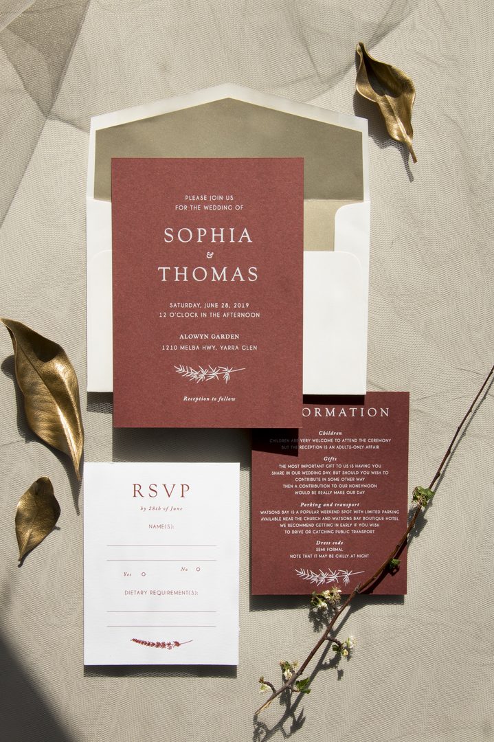 Paperlust invitation, Beautifully styled wedding suite flatlay with terracotta/marsala invitation