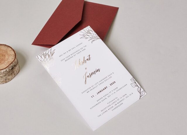 Paperlust invitation, Features decorative floral elements and gold foiling. Appears luxurious.