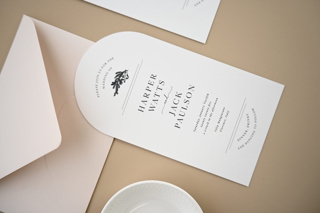 Paperlust invitation, Beautifully styled wedding invitation flatlay featuring an arch-shaped invitation for Harper Watts and Jack Paulson with a Florence
