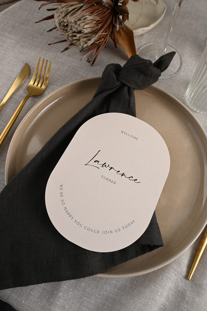 Paperlust place card, Beautifully styled place card on a neutral ceramic plate with dark linen napkin