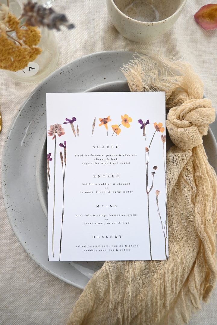Paperlust program, Beautifully styled wedding menu card with pressed wildflower illustrations
