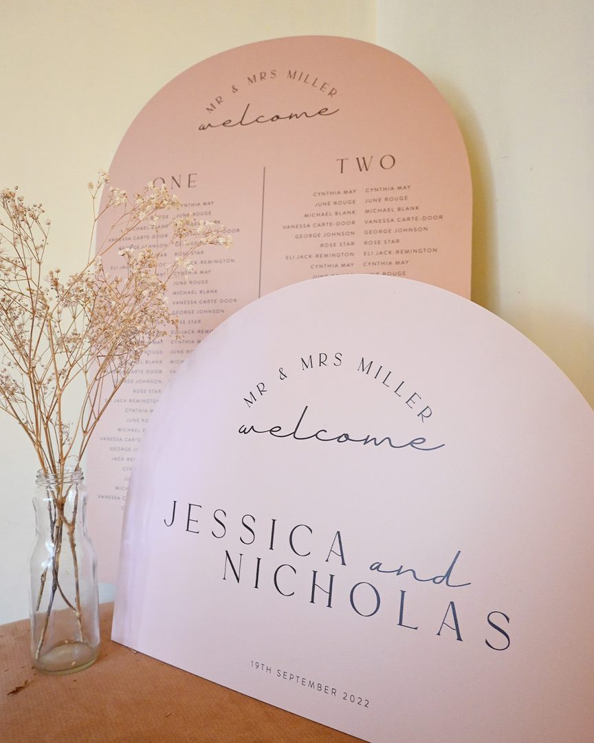 Paperlust seating chart, Wedding welcome sign and seating chart displayed together in a styled product shot. Soft blush/peach color palette with modern typography