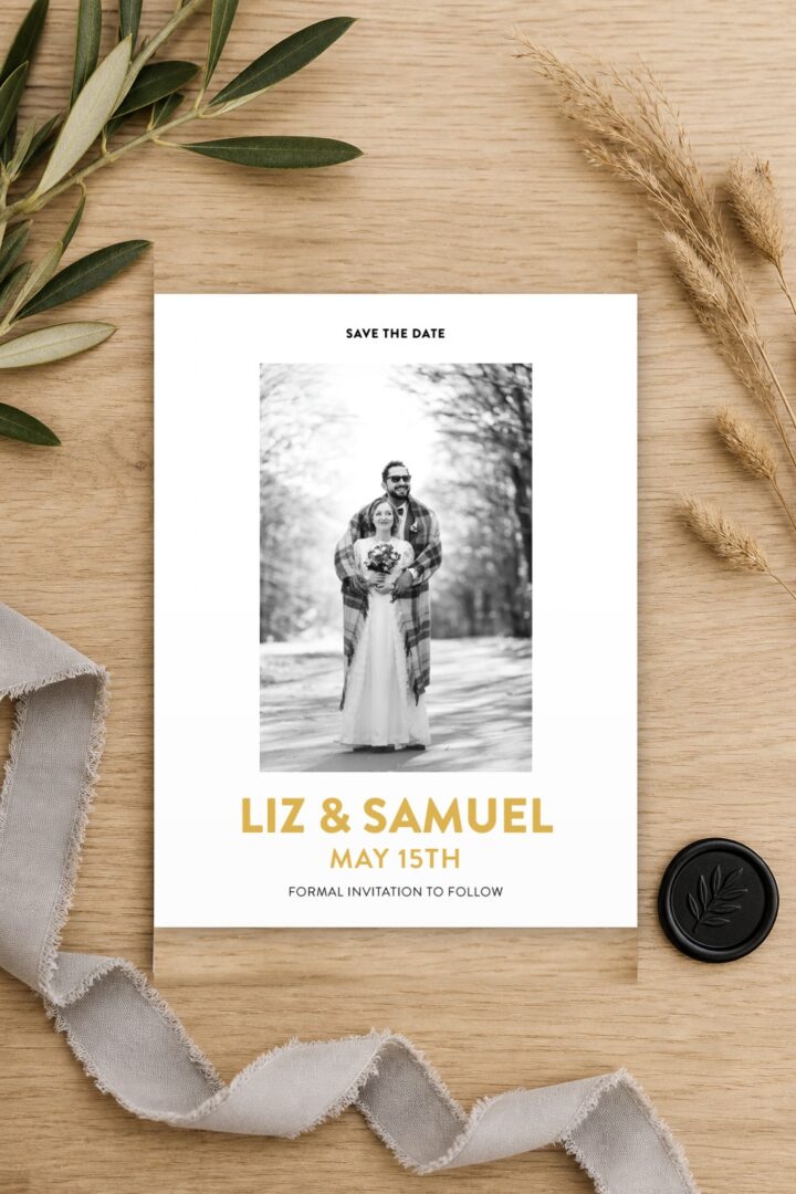 Paperlust photo save the date card featuring a black and white engagement photo with the couple names set in gold lettering