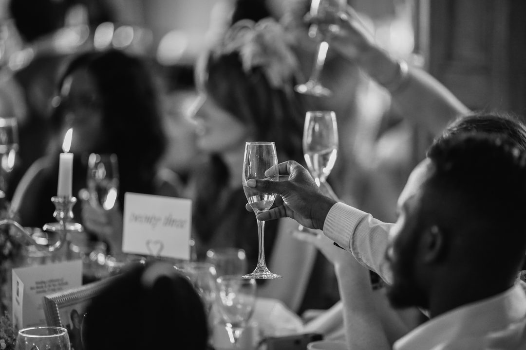 Guests raising their glasses for a celebratory wedding toast