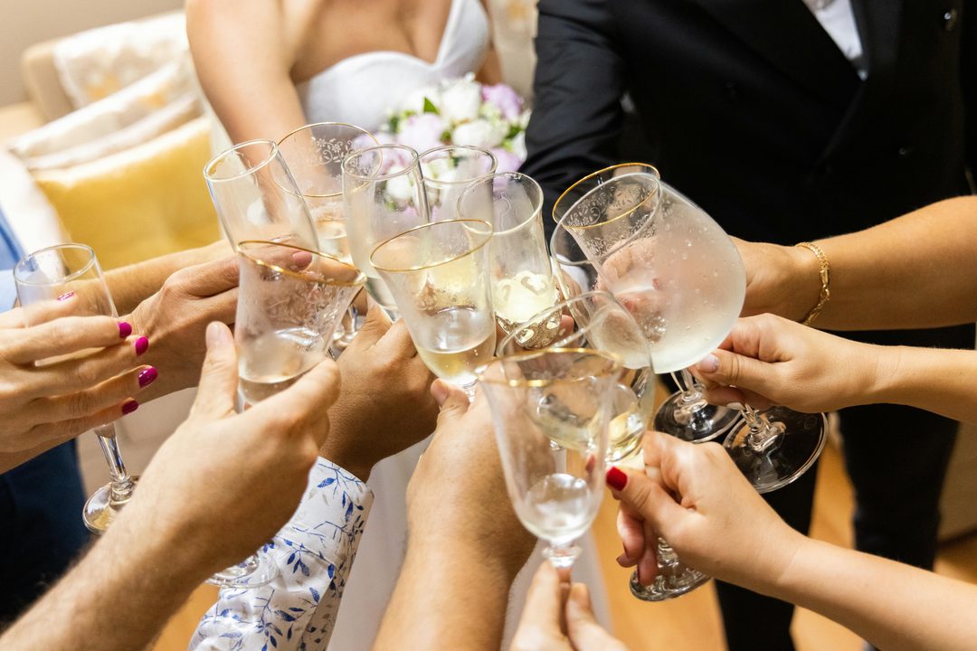 Guests toasting with champagne glasses at a wedding celebration