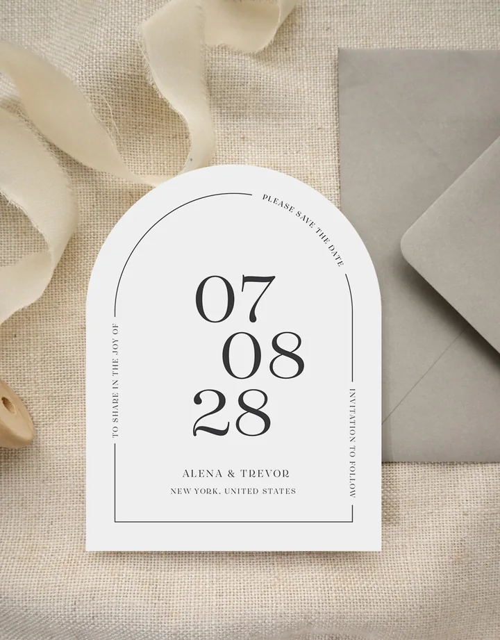 Paperlust All Minimal save the date, arch die-cut card with oversized 07.08.28 date and fine serif typography beside a grey envelope