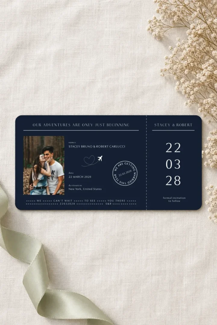 Paperlust Us and the World save the date, navy boarding pass card with names, date and destination fields, plane motif and couple photo