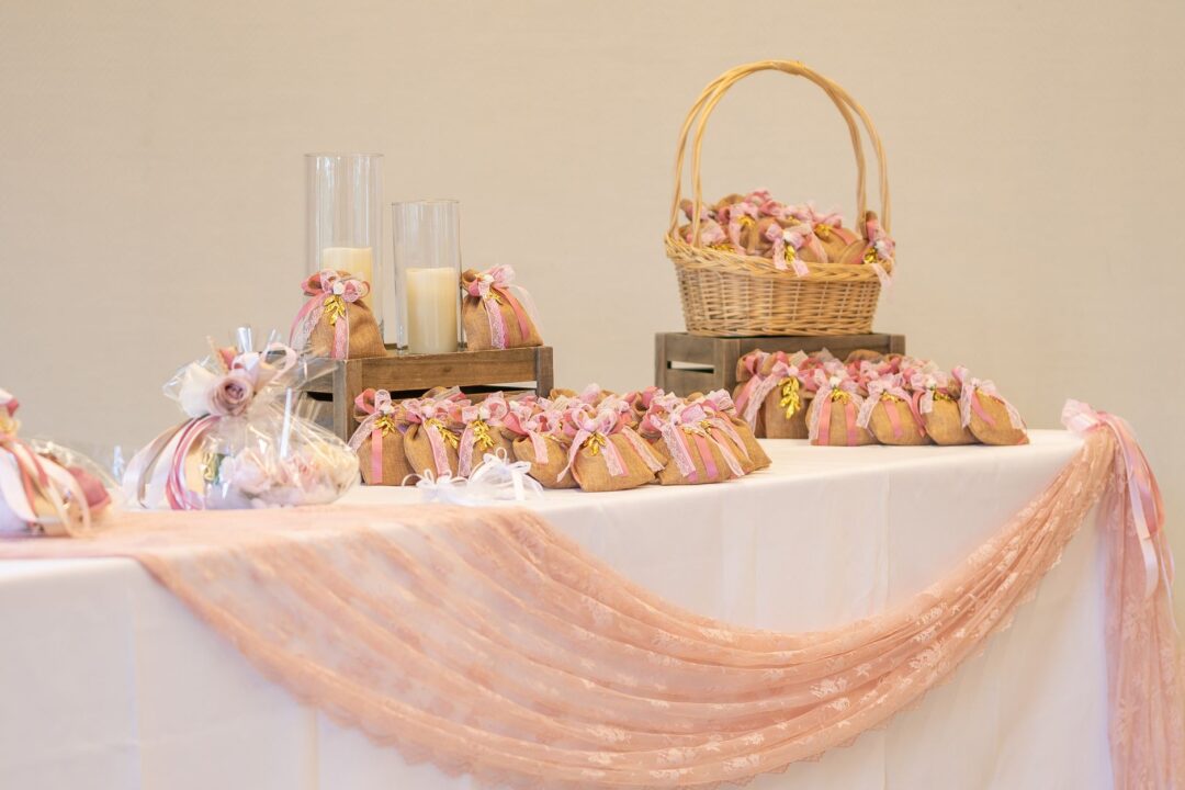 Actual wedding FAVORS, favor boxes, personalised gift boxes/bags, or wrapped favors laid out for guests at place settings