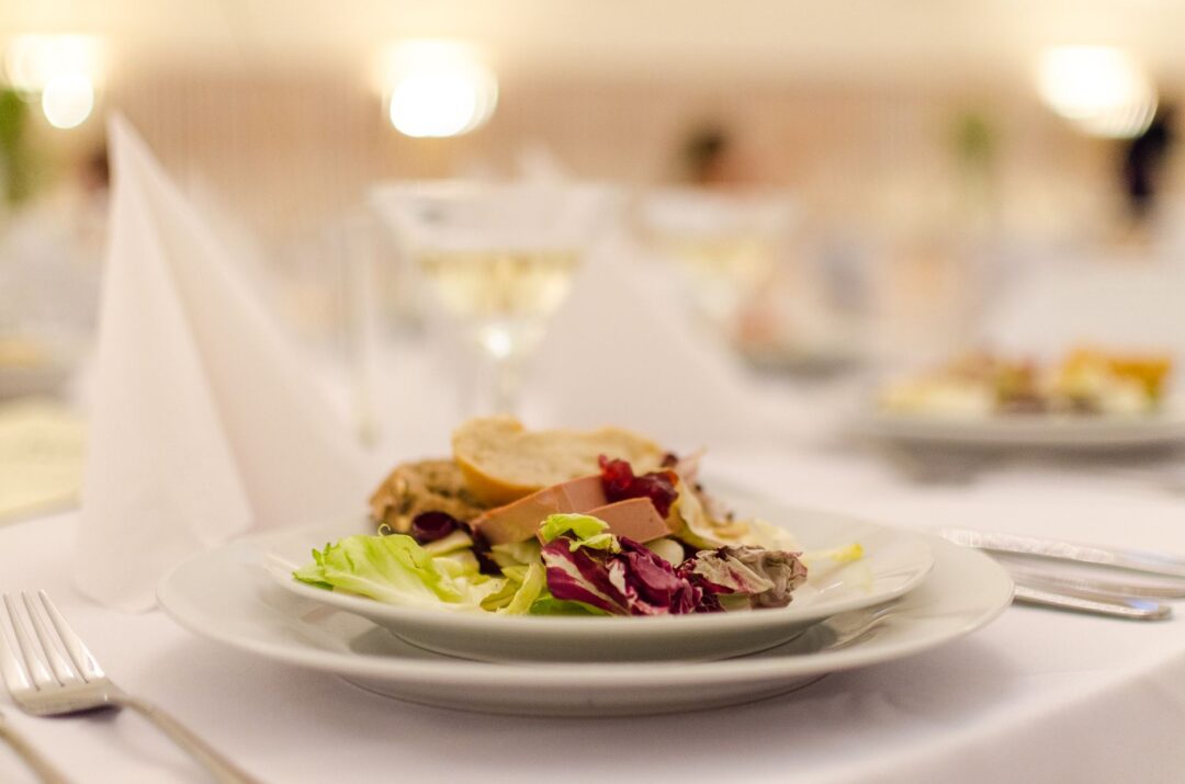 Wedding catering food service, plated wedding dinners, a catering buffet/chafing station, or catering staff serving at a...