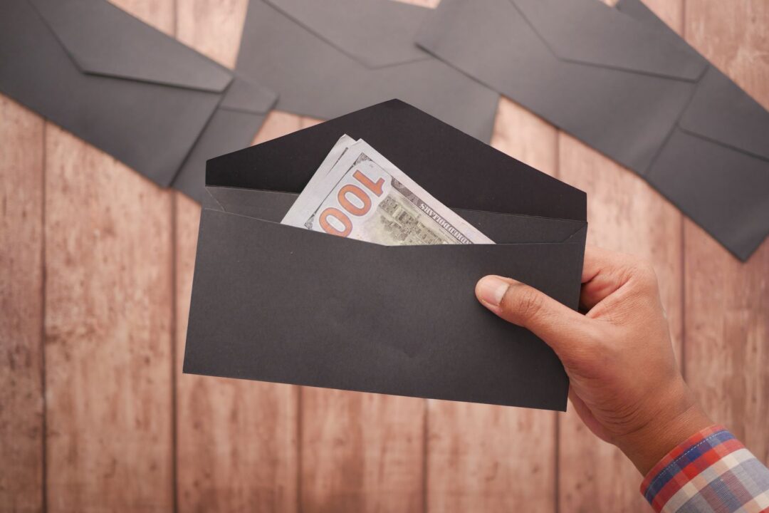 TIPPING / gratuity scene, cash or banknotes, a tip envelope, or a hand giving money / an envelope of money to someone