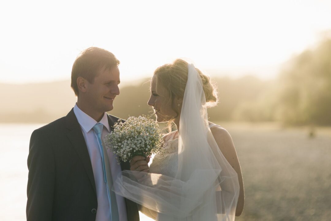 Bride and groom sharing a quiet moment at golden hour on their wedding day