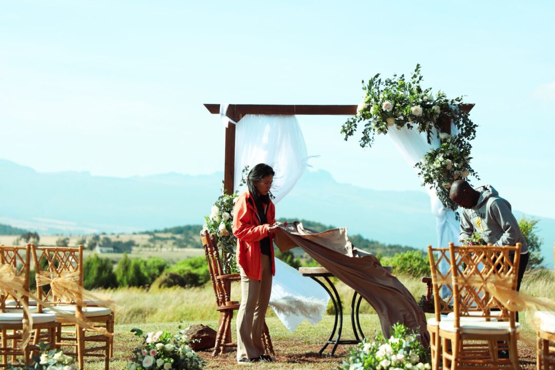 Wedding coordinator DIRECTING or coordinating at a real wedding venue (checklist, earpiece, guiding setup or staff)