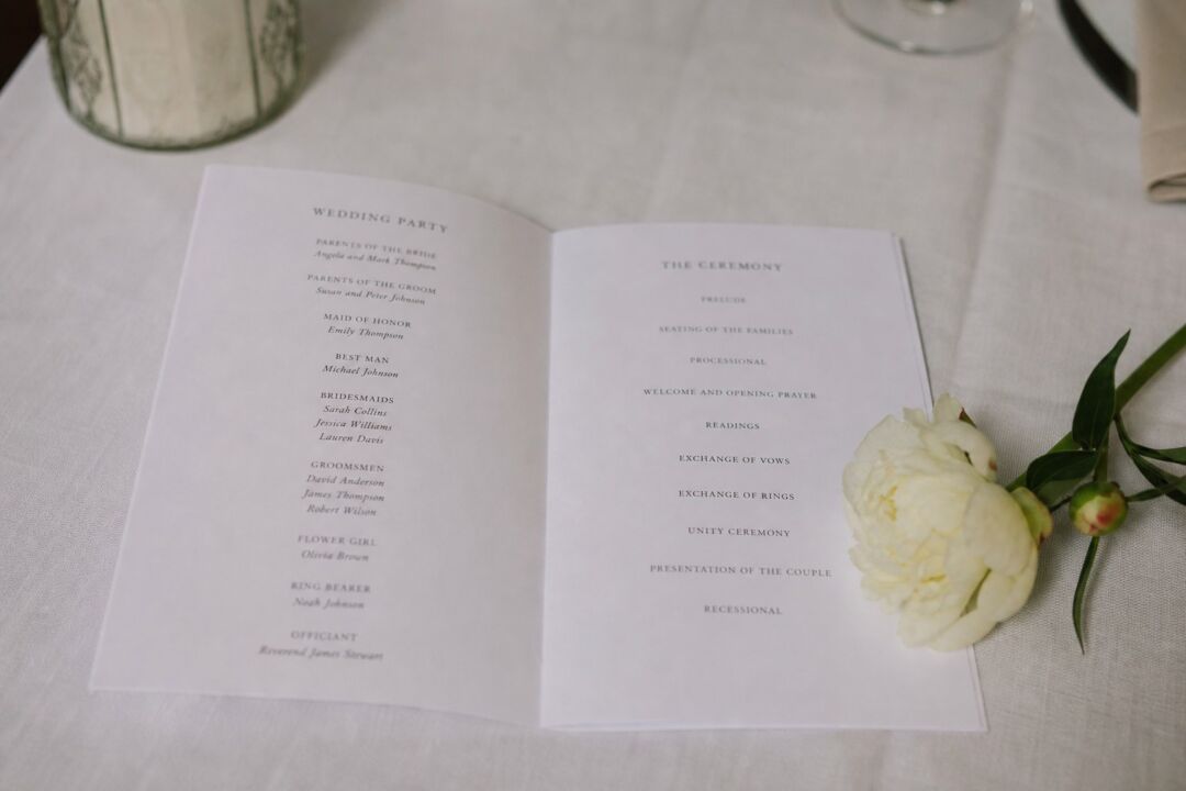 A printed wedding ceremony program open to the interior listing the wedding party members and ceremony order.
