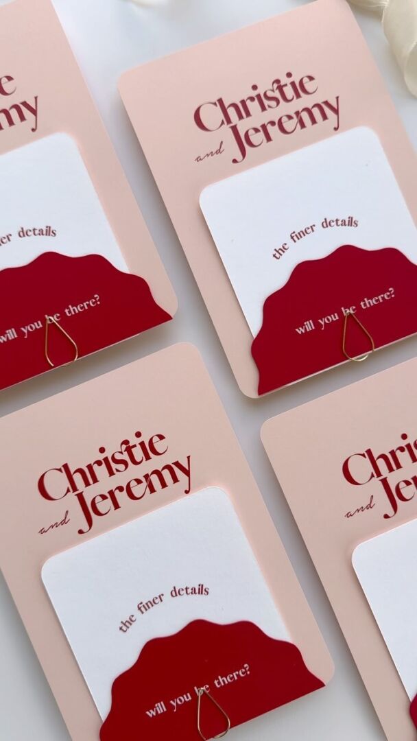Custom stacked invitations with red and pink wavy die-cut cards.