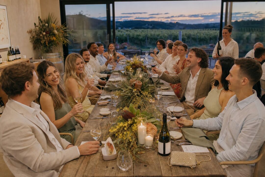 Long-table winery reception in a cellar-door dining room.