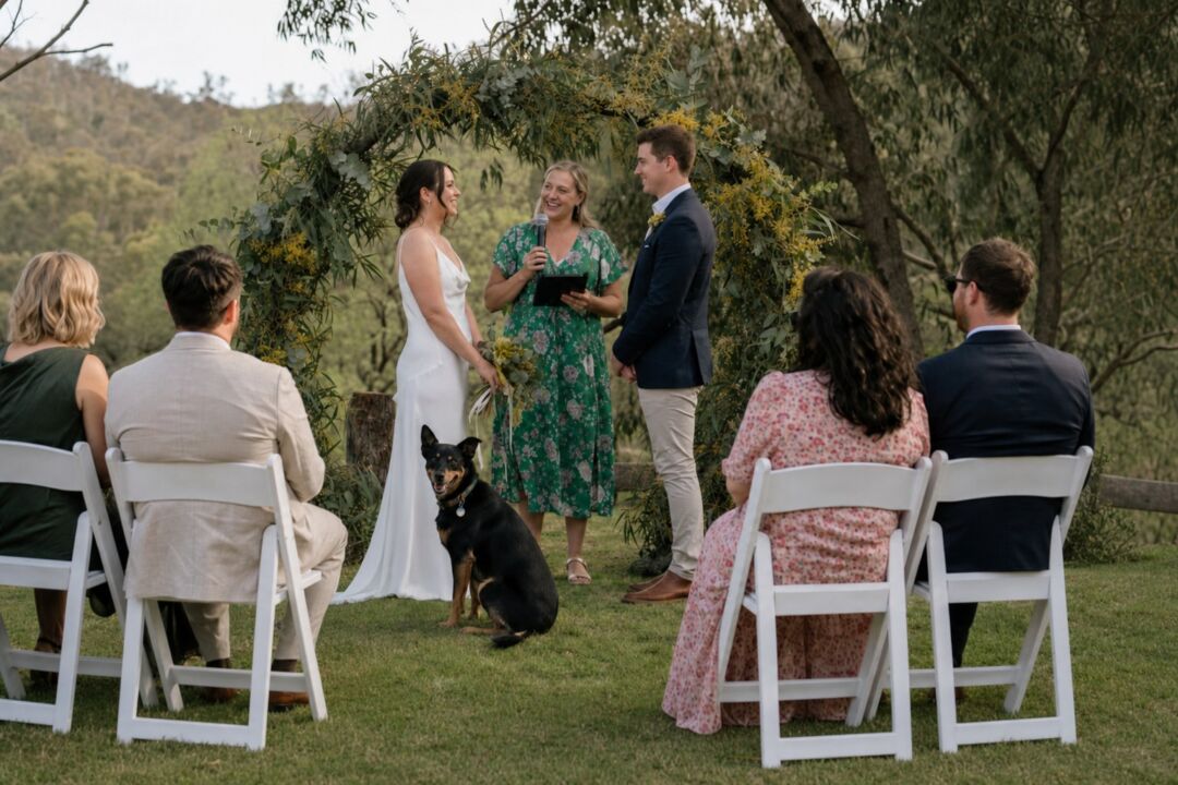 A printed welcome sign sits on the grass at the front of the ceremony frame.