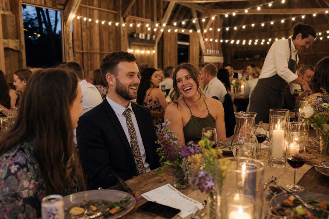 A barn wedding reception interior at evening.
